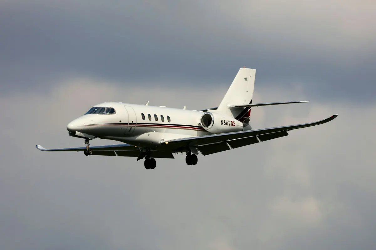 Business jet in flight against a grey sky