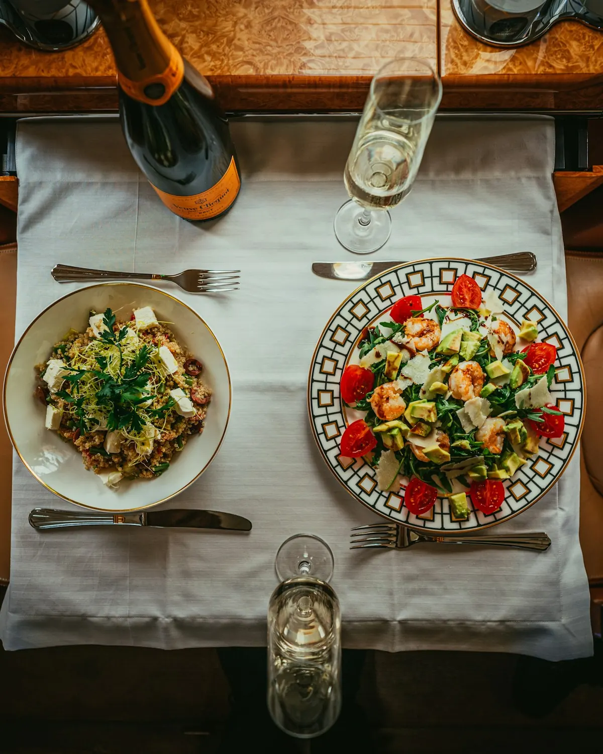 A table set with salads, bread and drinks, seen from above