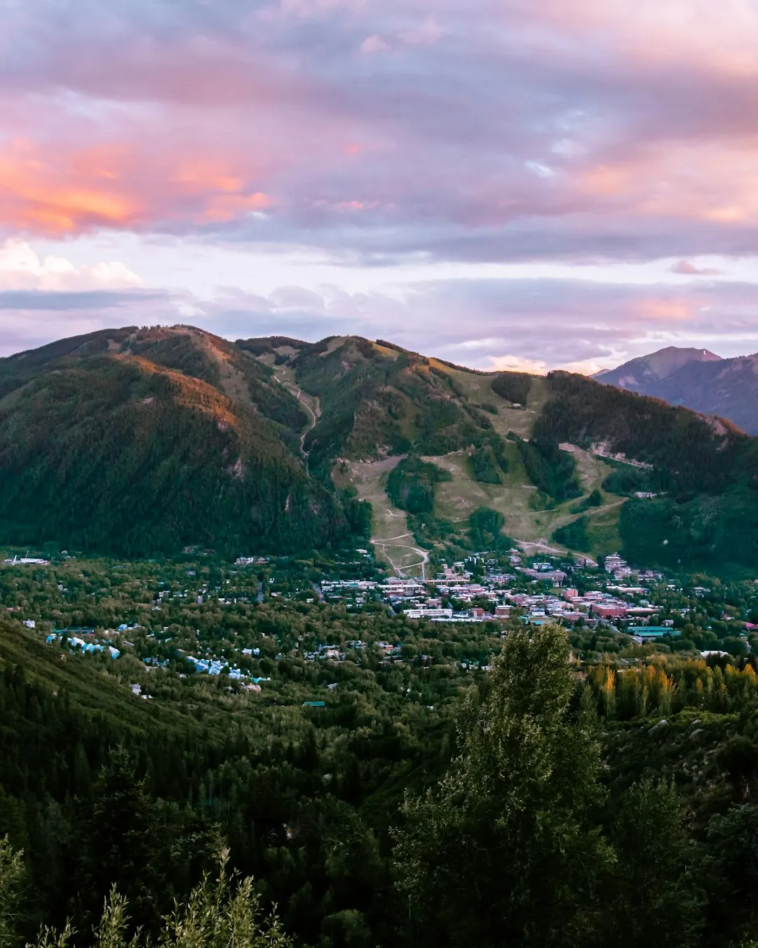 The town of Aspen at sunset below its ski mountain