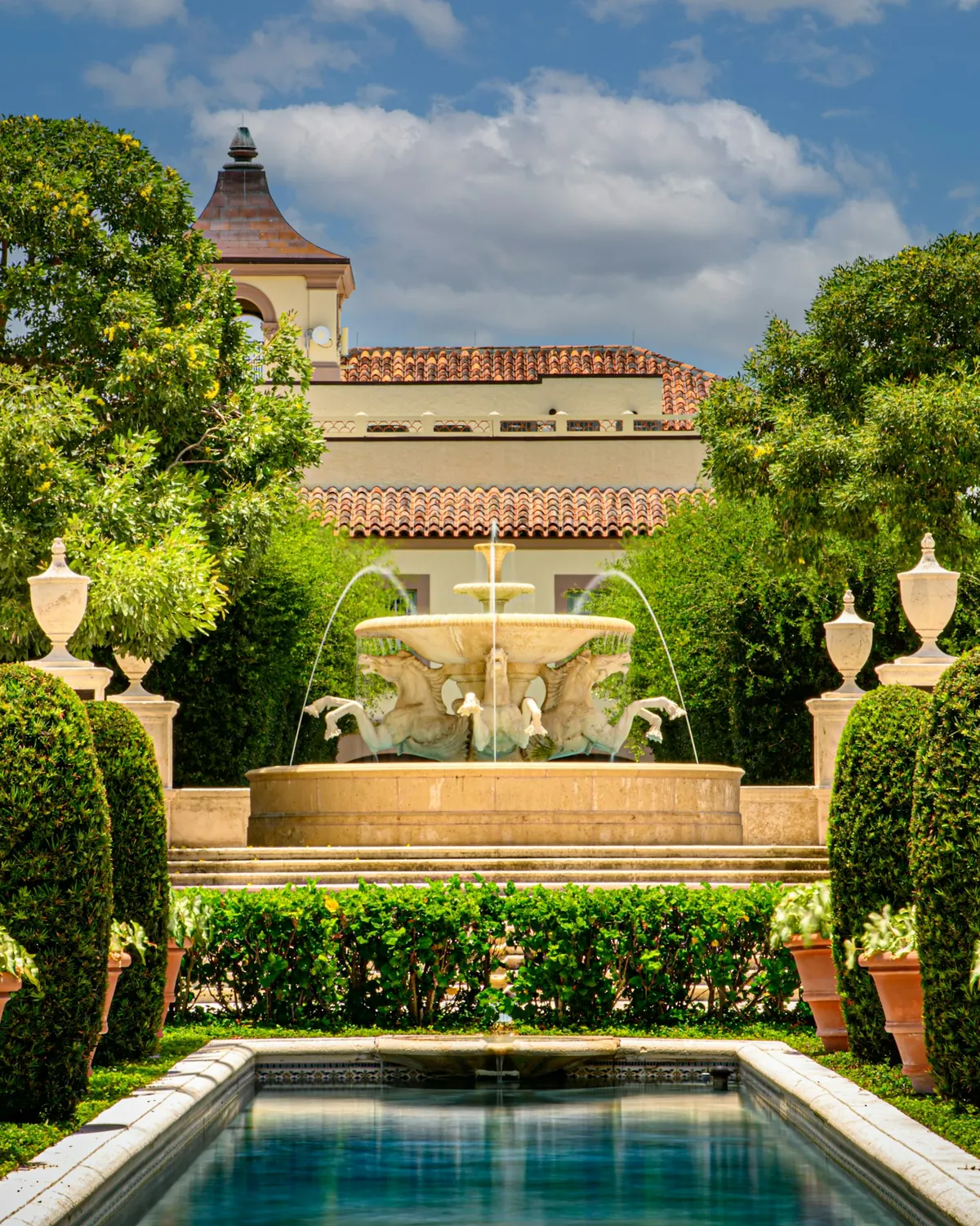 Formal garden with fountains and clipped hedges in Palm Beach